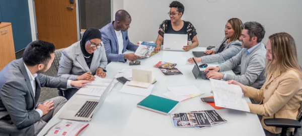 Conference room with seven people in a training session