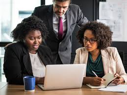 Diverse group of business professionals looking at a computer screen