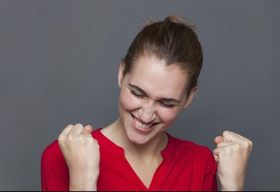 Woman celebrating by pumping fists