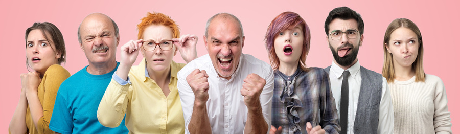 Seven people expressing different emotional reactions to something.