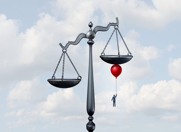 illustration: scale of justice, with clouds in the background, man holding a red balloon under the higher scale