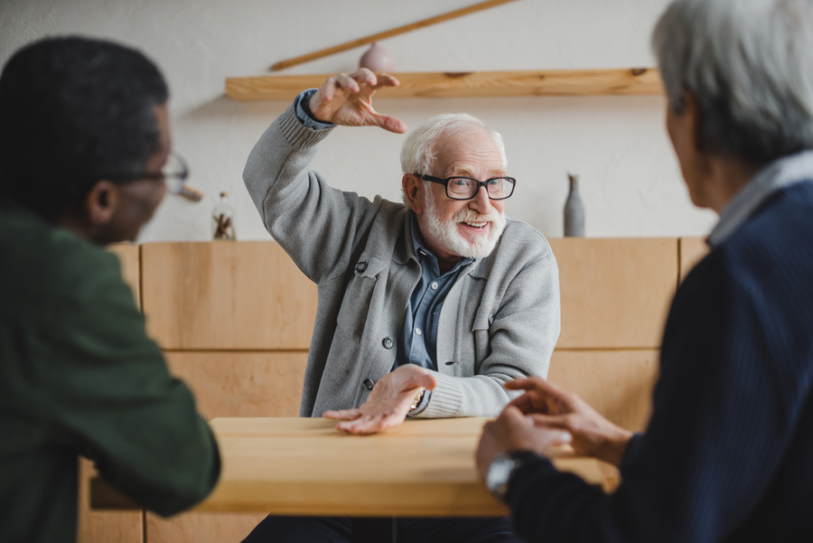 Man enthusiastically telling a story to two other people