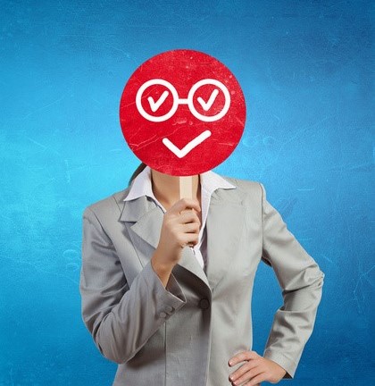 Woman holding fake smile sign in front of face