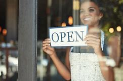 Woman holding an open sign